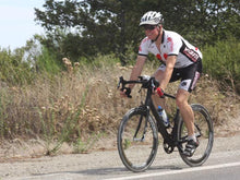 Load image into Gallery viewer, Road biker riding with a Da Brim Rezzo helmet visor in gray.