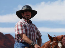 Load image into Gallery viewer, Male rider and horse. Rider is wearing the Da Brim Equestrian Endurance helmet brim visor in gray.