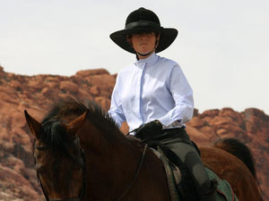 Female rider on a horse. Rider is wearing the Da Brim Equestrian Petite Helmet Brim Visor in black.
