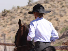 Load image into Gallery viewer, Rider practicing in an outdoor ring. She is wearing the Da Brim Equestrian Petite Helmet Brim Visor in black.