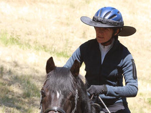 Horse and rider. Rider is wearing the Da Brim equestrian endurance helmet brim visor in black and is well shaded.