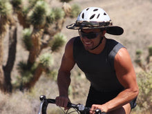 Load image into Gallery viewer, Male road cyclist pictured riding in the desert with a Da Brim Sporty Cycling Helmet Visor Brim.