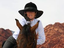 Load image into Gallery viewer, Rider smiling on her horse. She is wearing the Da Brim Equestrian Petite Helmet Brim Visor