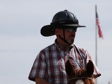 Load image into Gallery viewer, Male rider on horse with American flag in background. Rider is wearing the Da Brim Equestrian Petite Helmet Brim Visor in black.