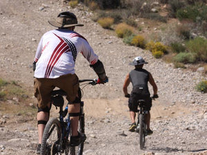 Two mountain bikers riding downhill while wearing the Da Brim Sporty Cycling Helmet Visor Brim